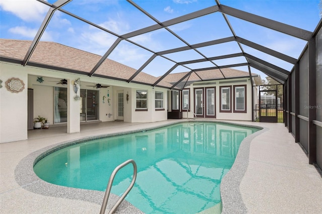 view of swimming pool with a patio, a lanai, and ceiling fan