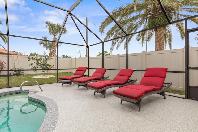 view of swimming pool featuring a patio and glass enclosure