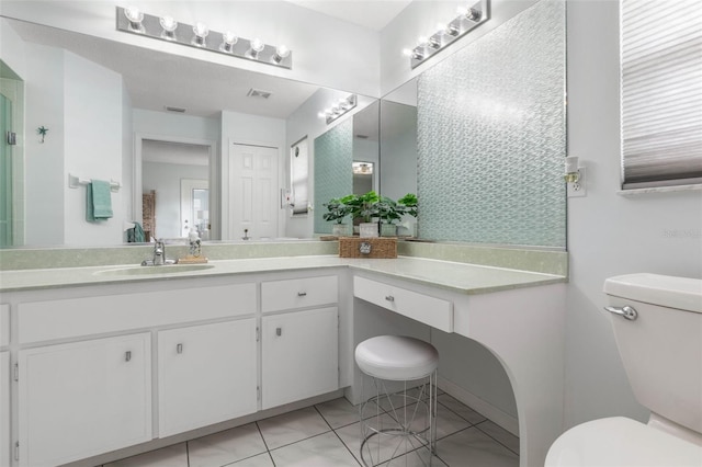 bathroom with vanity, toilet, and tile patterned flooring