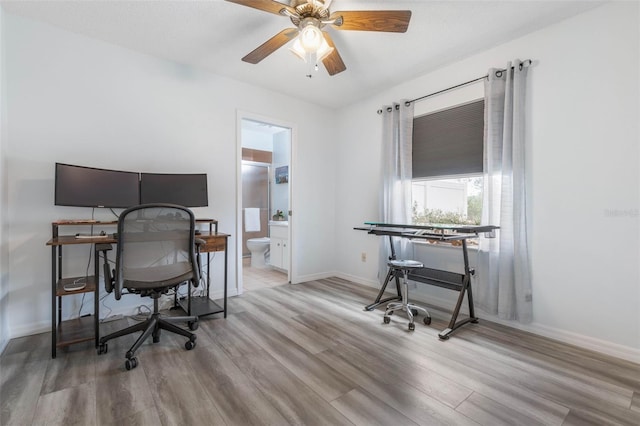 office area with light hardwood / wood-style floors and ceiling fan