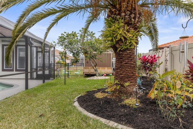 view of yard with a patio area and glass enclosure