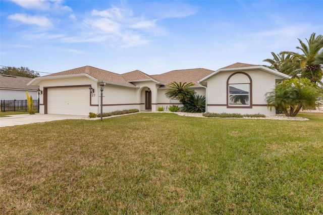 view of front of house featuring a garage and a front lawn