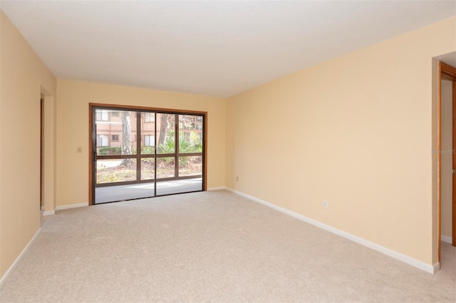 spare room featuring light colored carpet