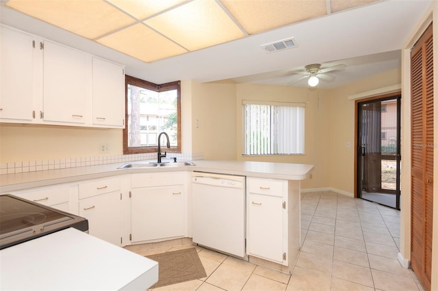 kitchen featuring light tile patterned flooring, dishwasher, sink, and kitchen peninsula