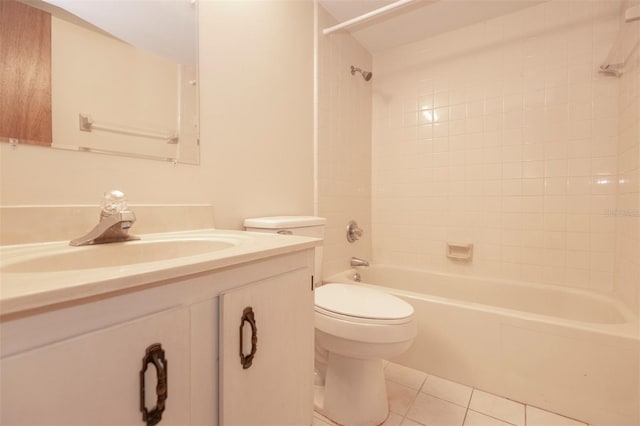 full bathroom featuring vanity, tiled shower / bath, tile patterned floors, and toilet