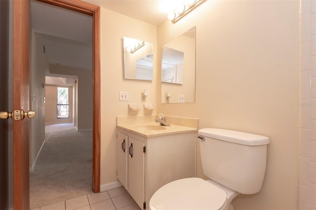 bathroom featuring tile patterned flooring, vanity, and toilet