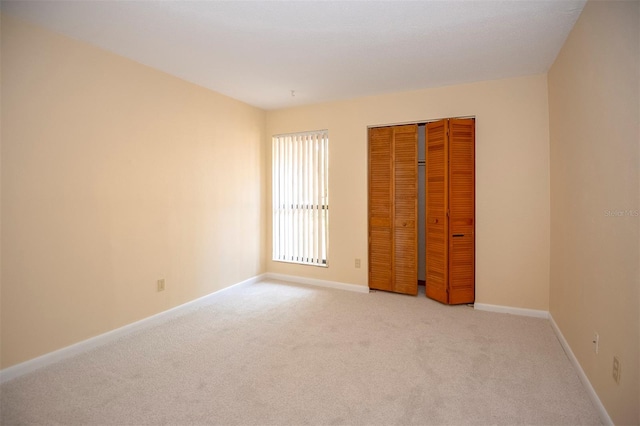 unfurnished room with light colored carpet