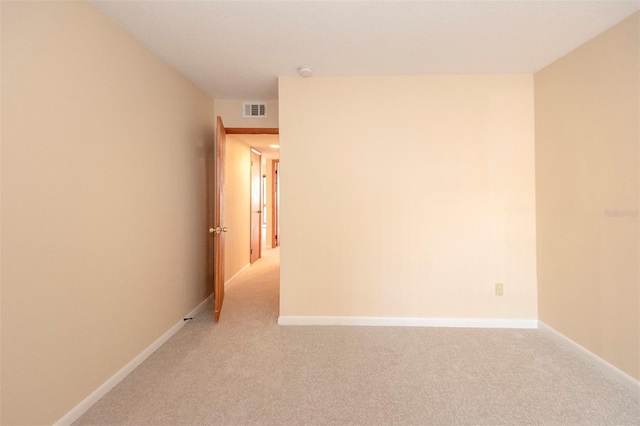 unfurnished room featuring light colored carpet