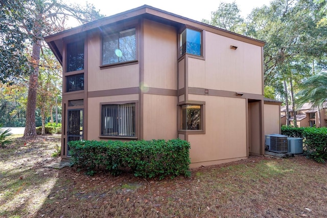 view of side of home with central AC unit