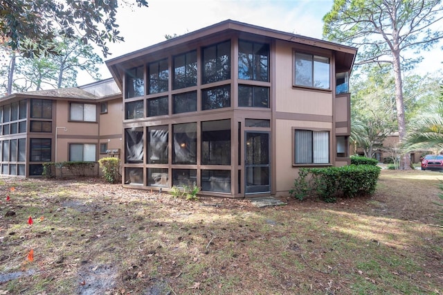 back of house with a sunroom