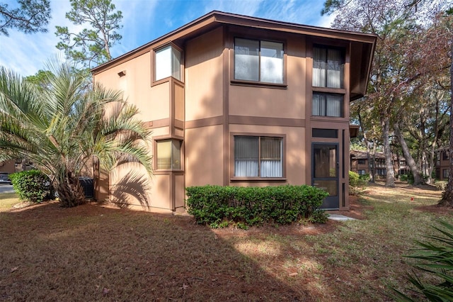 view of side of home with a lawn