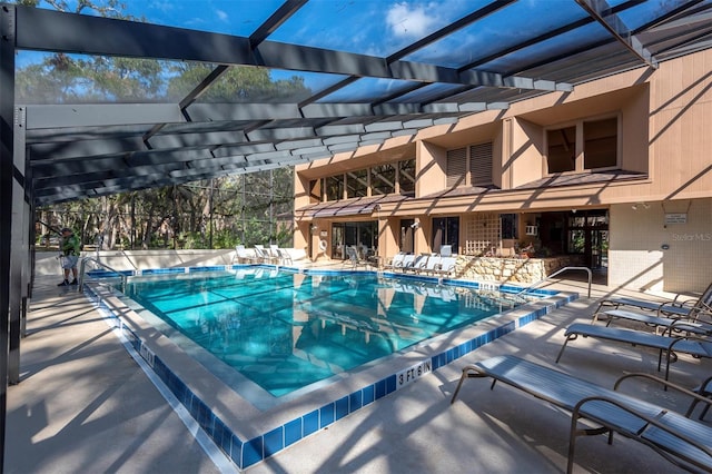 view of pool with a patio and a lanai