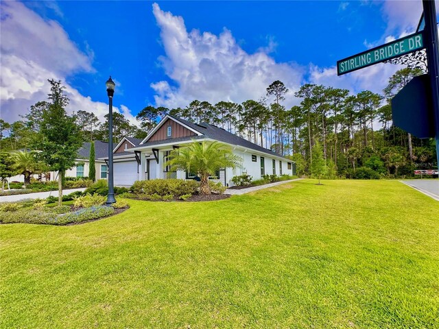 view of front of house with a garage and a front yard