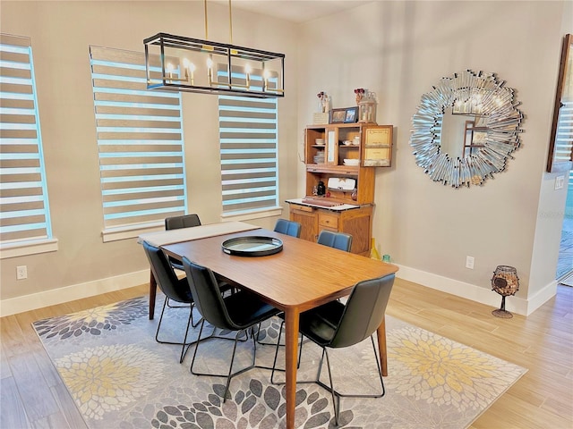 dining room featuring an inviting chandelier and light hardwood / wood-style floors