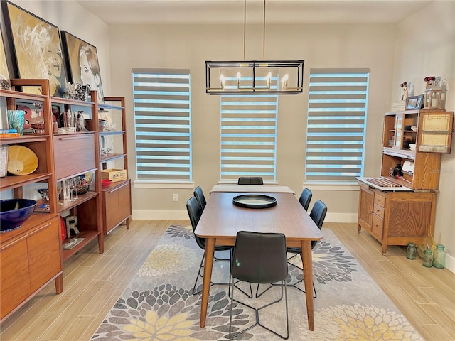 dining room with a notable chandelier and light hardwood / wood-style flooring