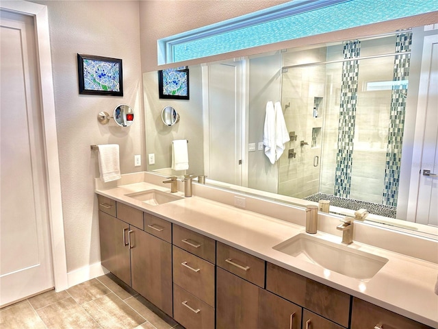 bathroom with tile patterned floors, vanity, and a shower with shower door