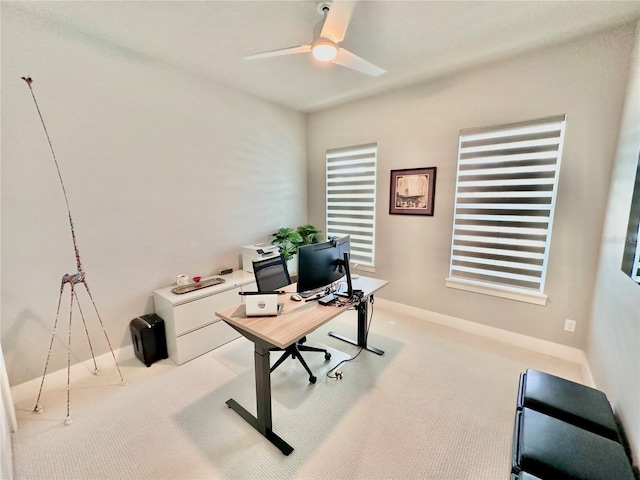 carpeted office featuring ceiling fan