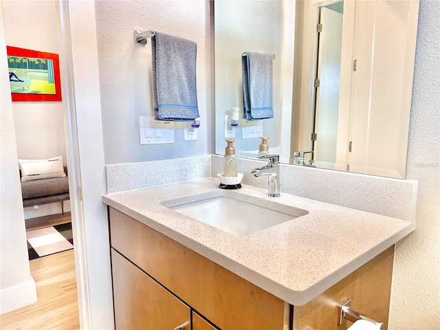 bathroom featuring hardwood / wood-style flooring and vanity