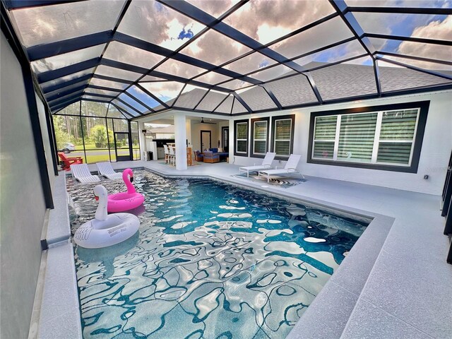 view of swimming pool featuring an outdoor living space, a lanai, and a patio area