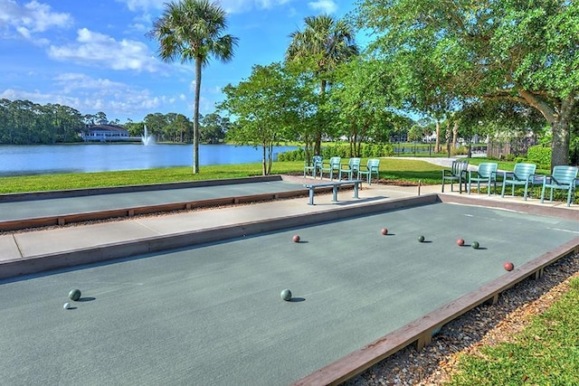 view of property's community featuring a yard and a water view