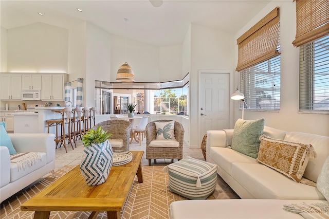 tiled living room with high vaulted ceiling