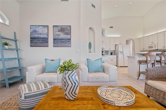 tiled living room with high vaulted ceiling