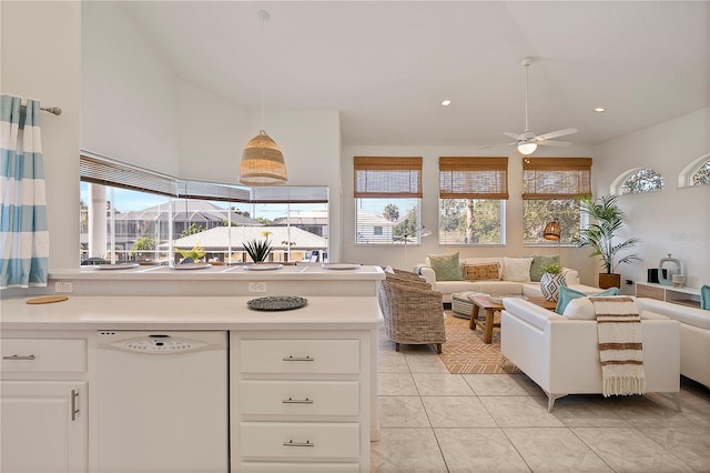 kitchen featuring light tile patterned floors, dishwasher, ceiling fan, hanging light fixtures, and white cabinets