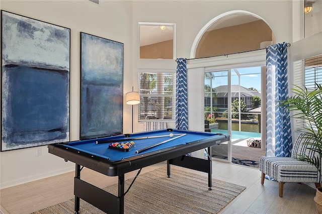 playroom with a wealth of natural light, hardwood / wood-style floors, and billiards