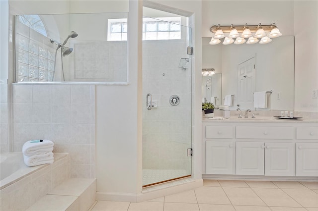 bathroom featuring tile patterned flooring, vanity, and separate shower and tub