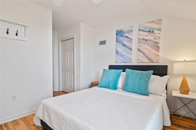 bedroom with ceiling fan, hardwood / wood-style floors, and a closet