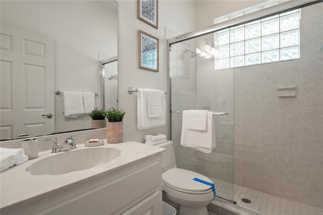 bathroom with vanity, walk in shower, and toilet