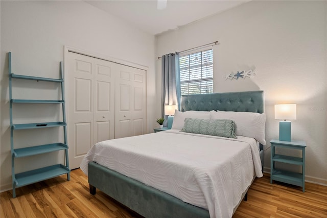 bedroom featuring ceiling fan, a closet, and light hardwood / wood-style flooring