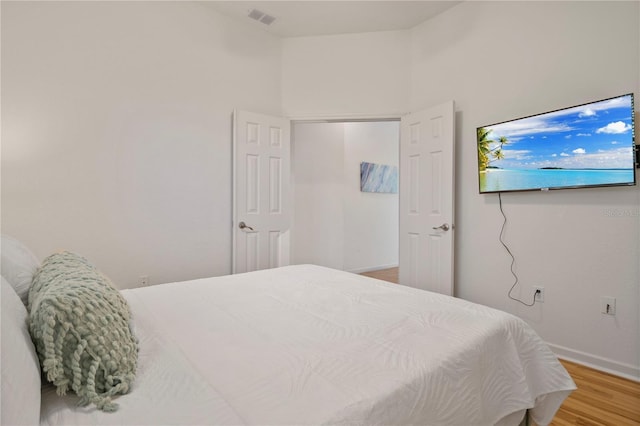 bedroom with hardwood / wood-style flooring