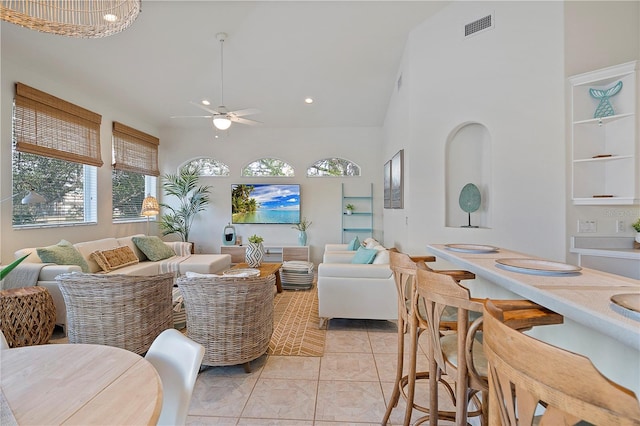 tiled living room with high vaulted ceiling and ceiling fan