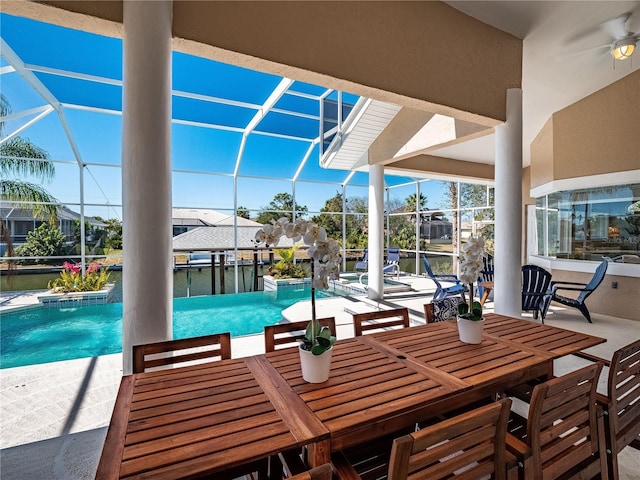 view of patio / terrace with a water view, a lanai, and a pool with hot tub