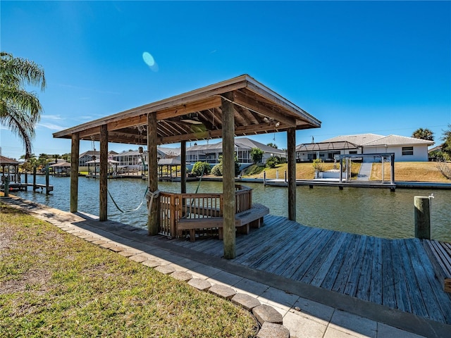 dock area with a yard and a water view