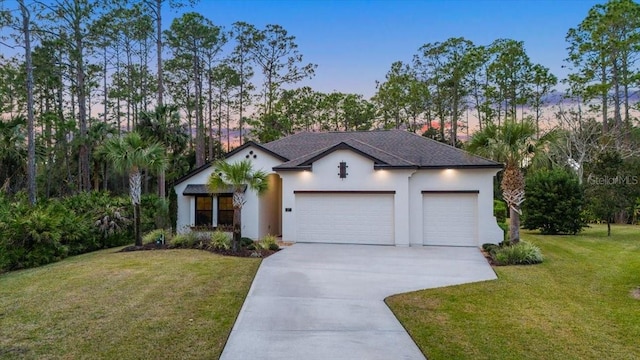 view of front of house with a yard and a garage