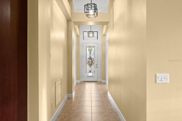 doorway to outside with light tile patterned floors