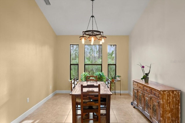 dining area with lofted ceiling, a notable chandelier, and light tile patterned flooring