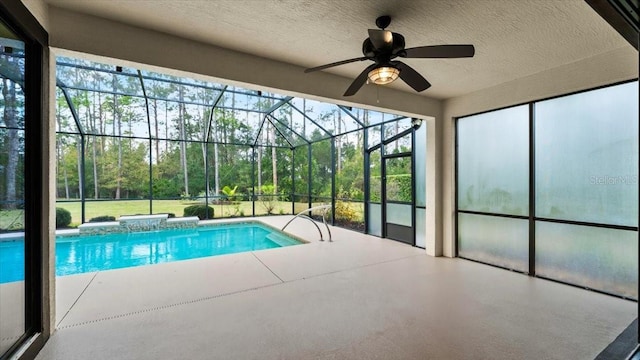 view of pool with a lanai, a patio, and ceiling fan