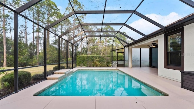 view of swimming pool with a lanai, a patio, and ceiling fan