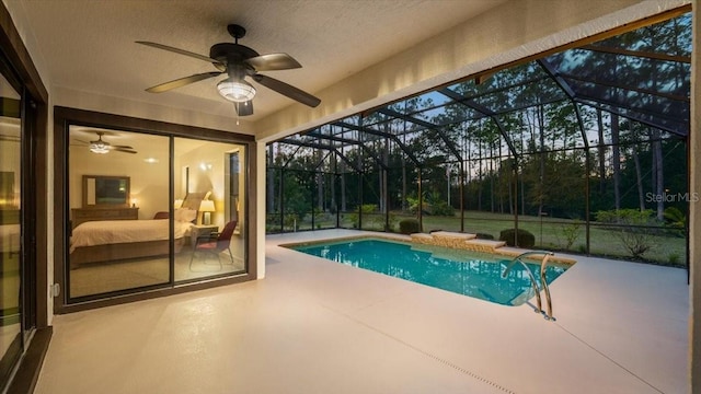 view of pool with a patio and glass enclosure