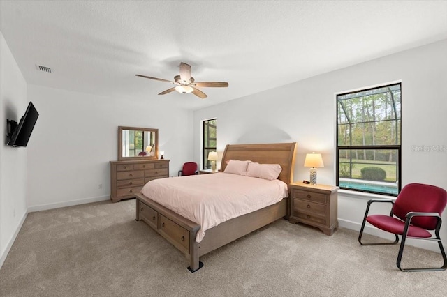 bedroom with light colored carpet and ceiling fan