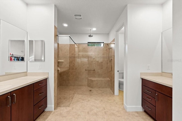 bathroom featuring vanity, an enclosed shower, and toilet