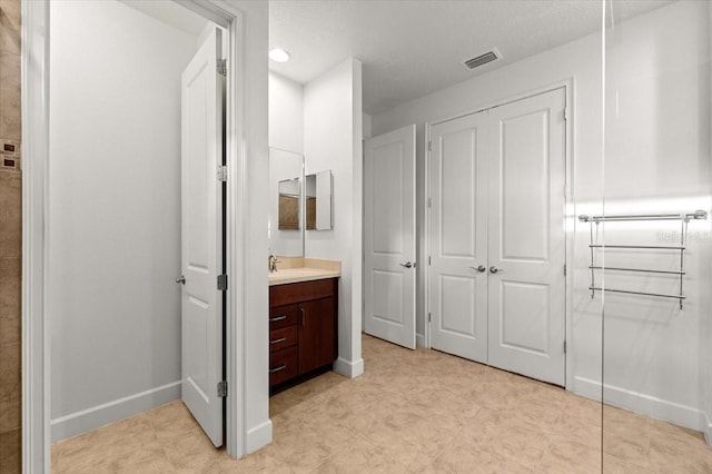 bathroom featuring vanity and a textured ceiling