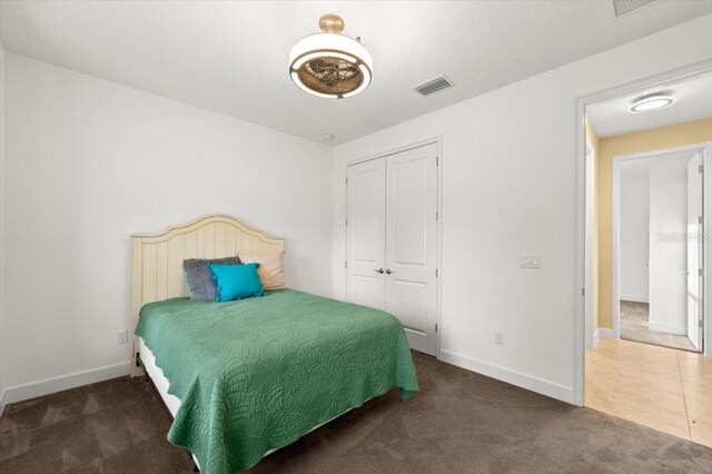 carpeted bedroom with a closet