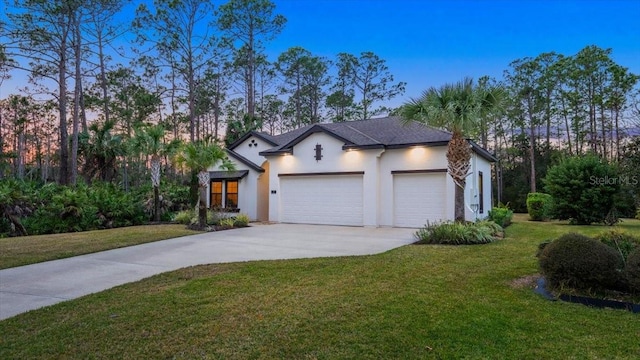 view of front facade featuring a garage and a lawn