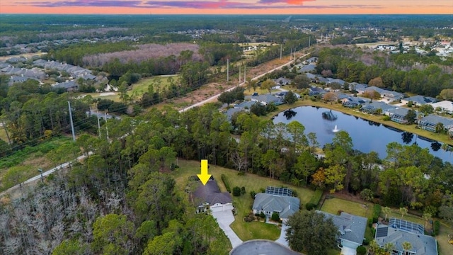 aerial view at dusk with a water view