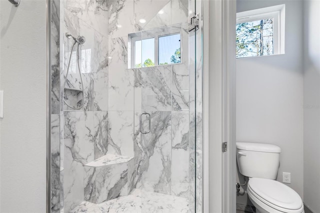 bathroom with an enclosed shower and toilet