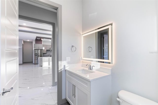 bathroom featuring vanity and toilet